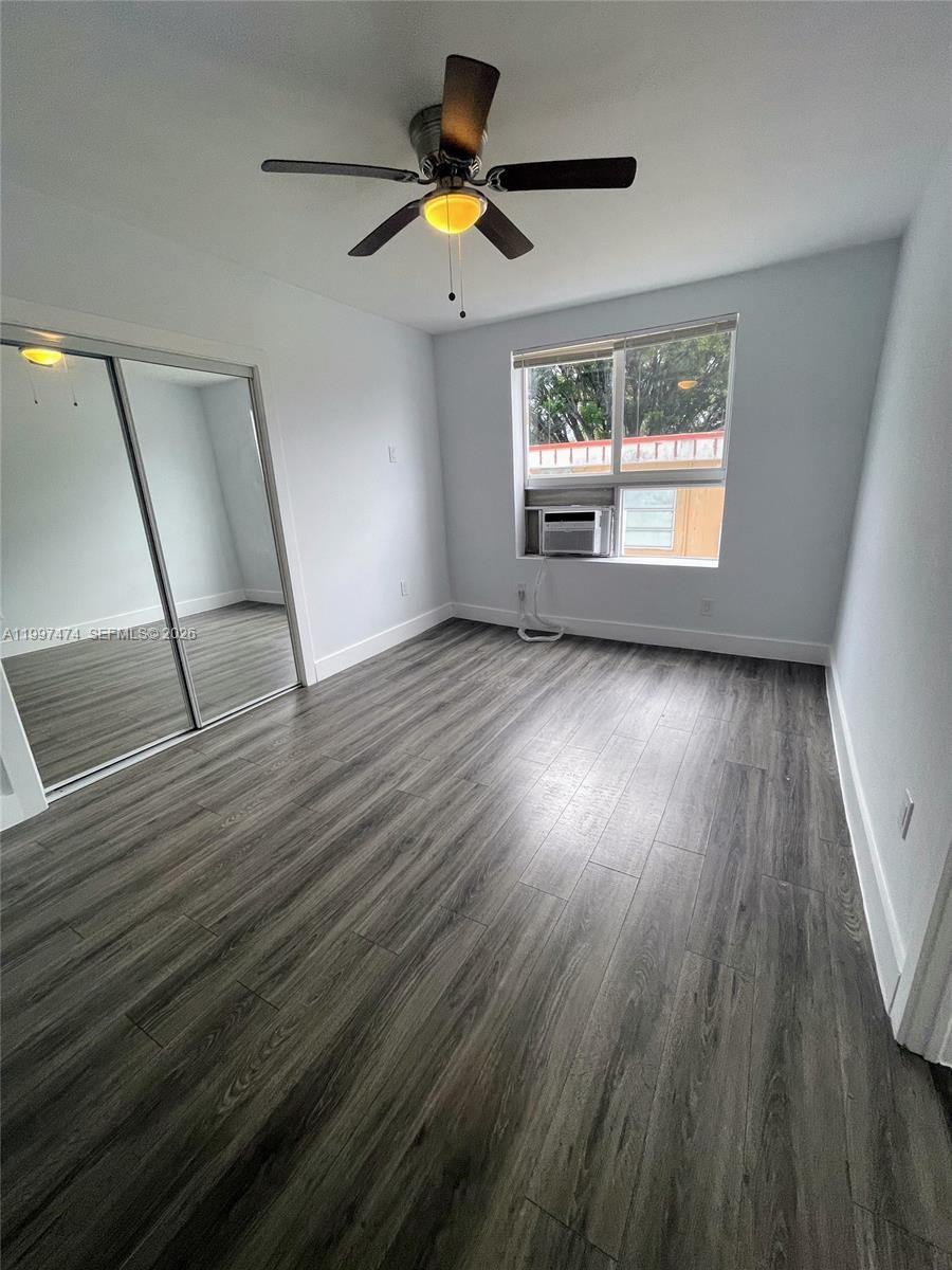 1036 Southwest 5th Street, Unit 8 Miami, FL 33130 - Photo 3 of 13 a view of empty room with wooden floor and fan