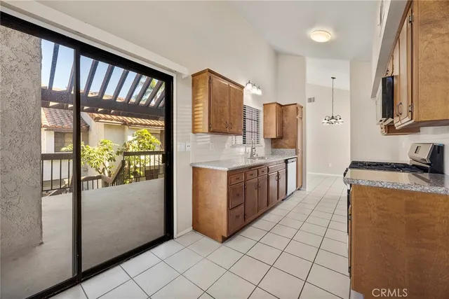 a kitchen with stainless steel appliances granite countertop a refrigerator and a stove