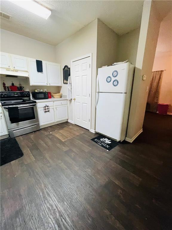 3607 Ginnis Road, Unit 2 Atlanta, GA 30331 - Photo 9 of 9 a kitchen with a refrigerator and white cabinets