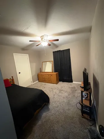 a bedroom with a bed and window