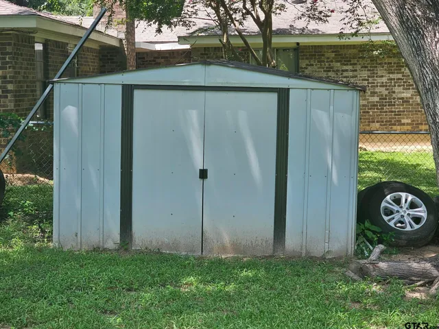 a view of a small yard with wooden fence