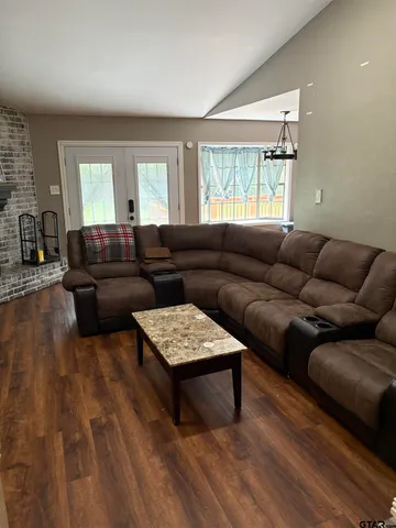 a living room with fireplace furniture and a flat screen tv