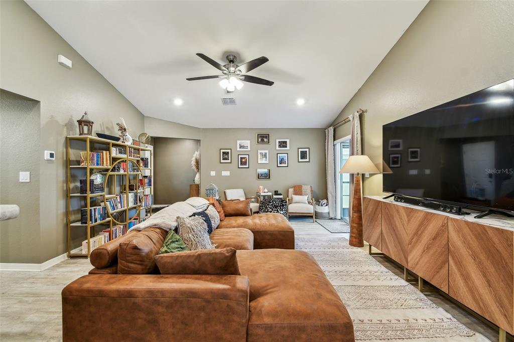 105 Blue Alice Spring Court Ruskin, FL 33570 - Photo 12 of 49 a living room with furniture and a flat screen tv