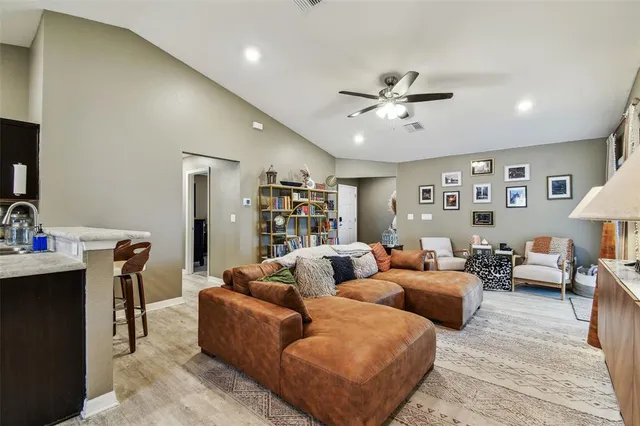 a living room with furniture ceiling fan and a rug
