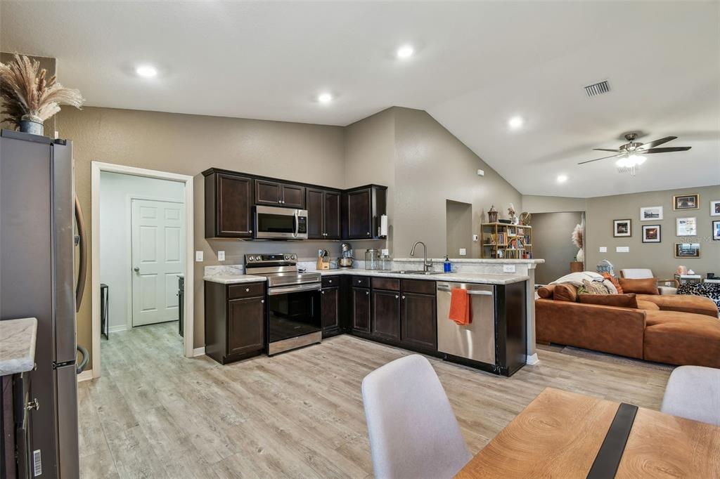 105 Blue Alice Spring Court Ruskin, FL 33570 - Photo 15 of 49 a large white kitchen with stainless steel appliances granite countertop a stove and a sink