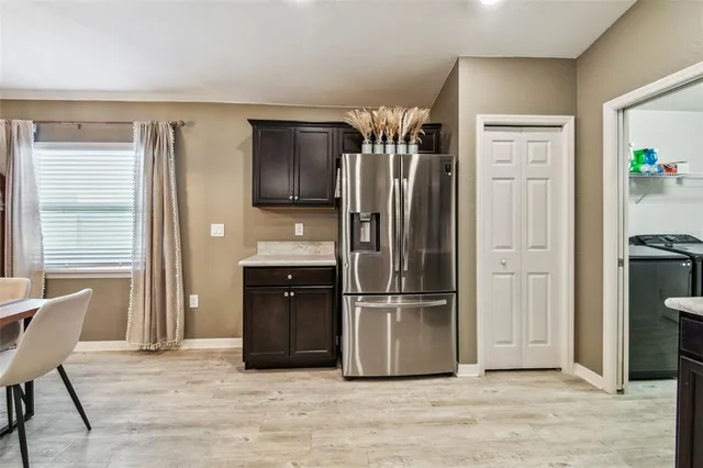 a kitchen with stainless steel appliances granite countertop a refrigerator and a sink