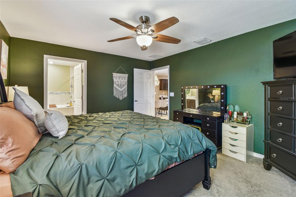 105 Blue Alice Spring Court Ruskin, FL 33570 - Photo 23 of 49 a bedroom with a bed and a television