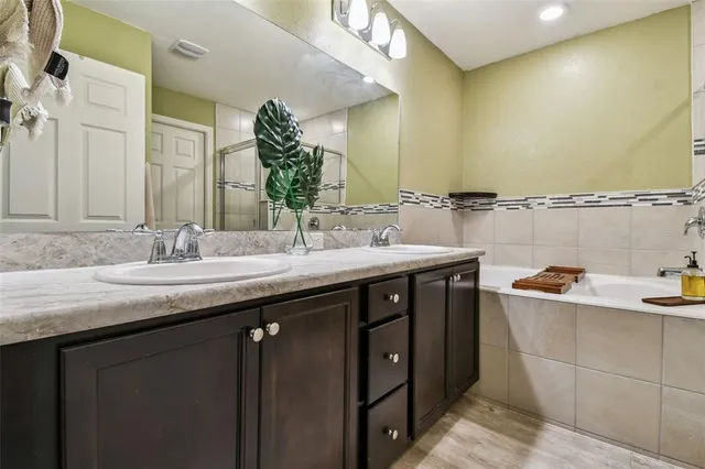 a bathroom with a granite countertop sink a large mirror and a