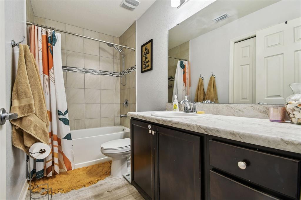 105 Blue Alice Spring Court Ruskin, FL 33570 - Photo 32 of 49 a bathroom with a granite countertop sink a toilet and shower