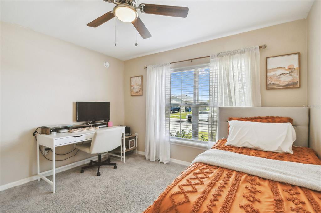 105 Blue Alice Spring Court Ruskin, FL 33570 - Photo 35 of 49 a bedroom with a bed and a window