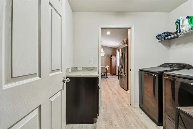 a kitchen with a refrigerator and a stove