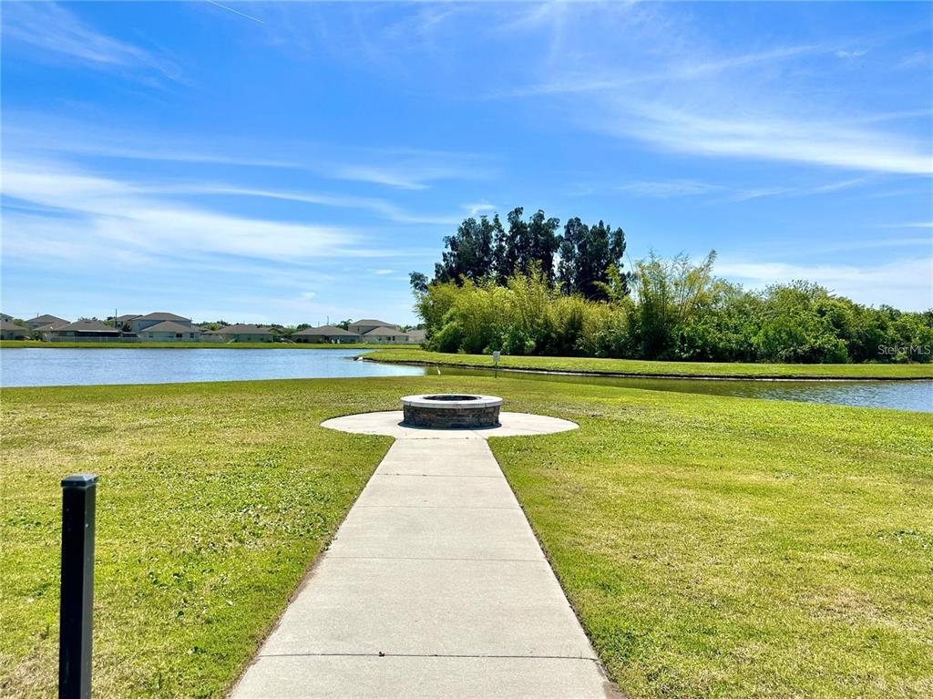 105 Blue Alice Spring Court Ruskin, FL 33570 - Photo 49 of 49 a view of a swimming pool and an outdoor seating
