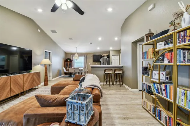 a living room with furniture lots of furniture and a flat screen tv