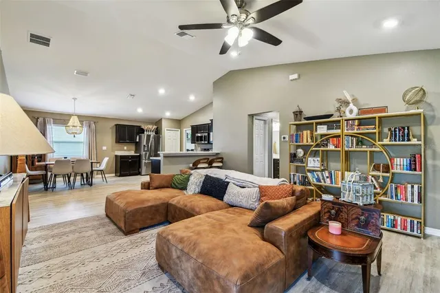 a living room with furniture and a book shelf