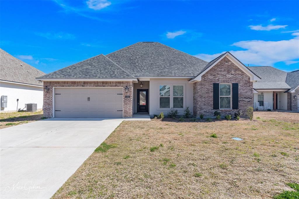 131 Brimestone Loop Benton, LA 71006 - Photo 1 of 1 Ranch-style home with a garage, a shingled roof, driveway, and central AC unit