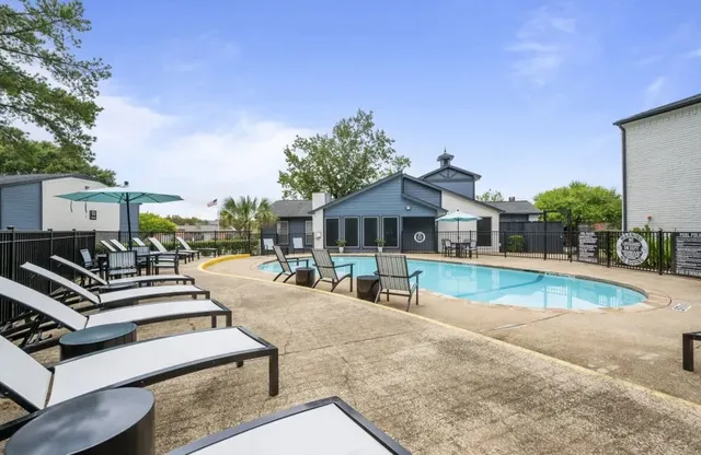 a view of a house with swimming pool and sitting area