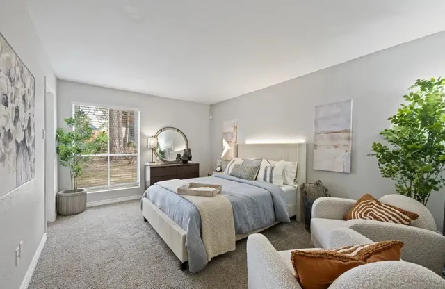 a spacious bedroom with two beds and a large window