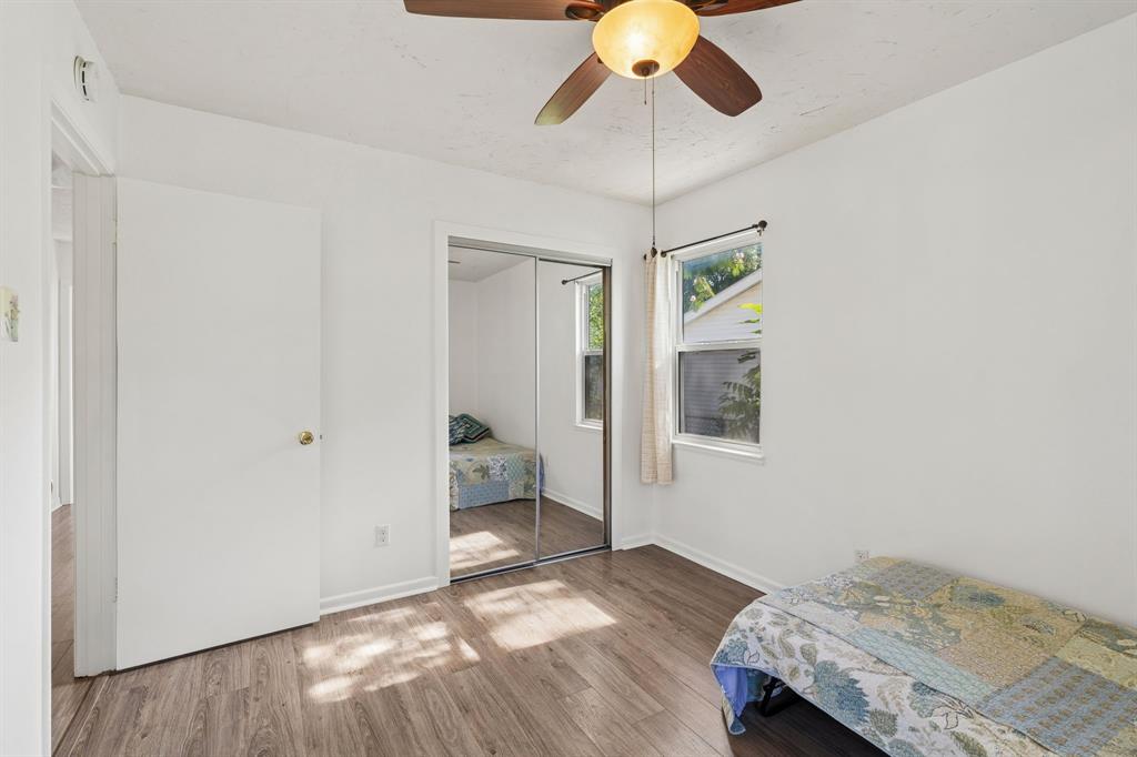 1822 Finley Road Irving, TX 75062 - Photo 28 of 38 a bedroom with a bed and a chandelier fan