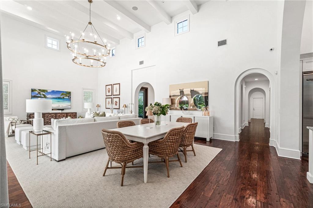 16755 Lucarno Way Naples, FL 34110 - Photo 5 of 50 a view of a dining room with furniture wooden floor and chandelier