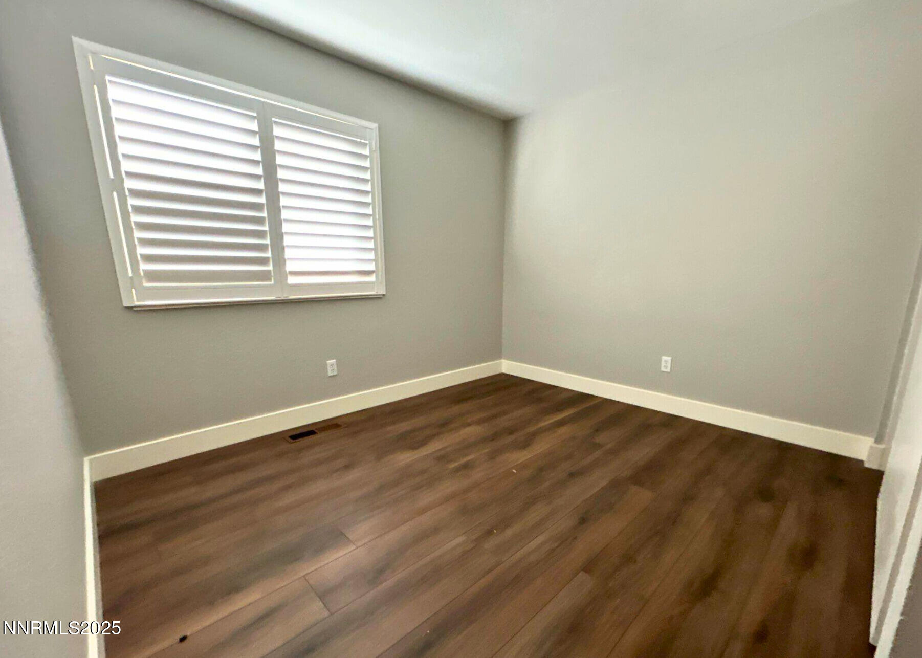 8657 Silver Shores Drive Reno, NV 89506 - Photo 6 of 12 an empty room with wooden floor and a window