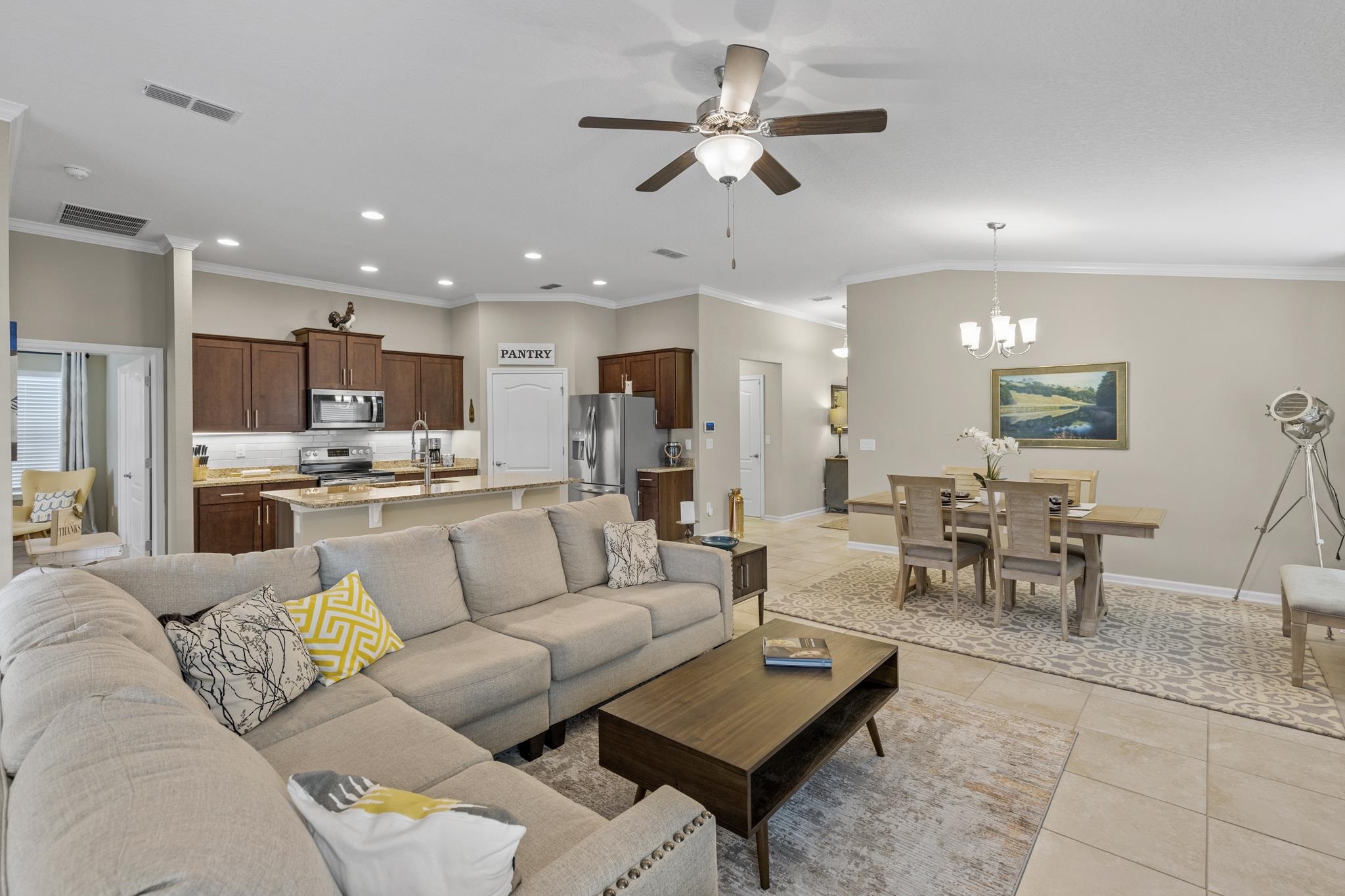 307 Palace Drive St. Augustine, FL 32084 - Photo 15 of 58 a living room with furniture kitchen view and a chandelier