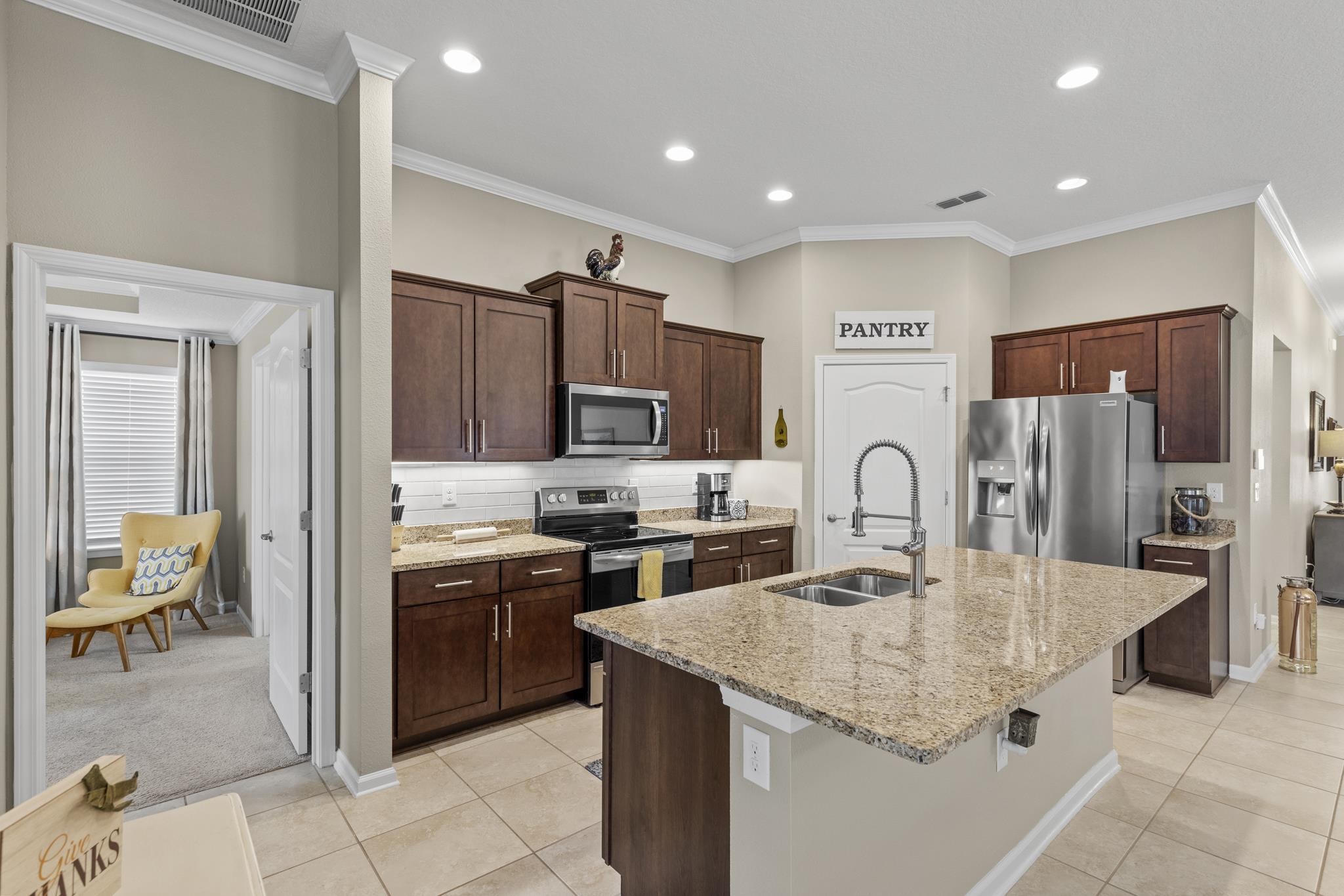 307 Palace Drive St. Augustine, FL 32084 - Photo 16 of 58 a kitchen with stainless steel appliances granite countertop a stove refrigerator sink and cabinets