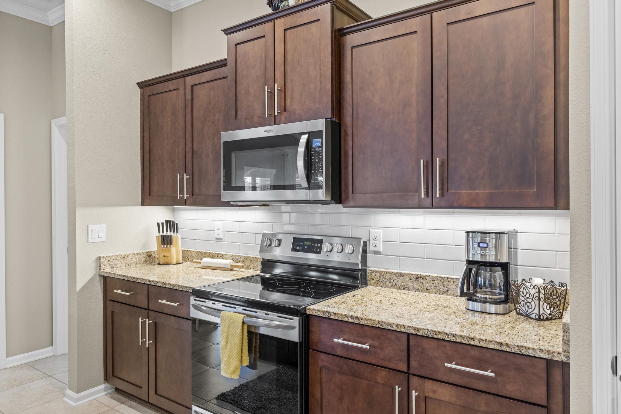 307 Palace Drive St. Augustine, FL 32084 - Photo 19 of 58 a kitchen with stainless steel appliances granite countertop a sink stove and microwave