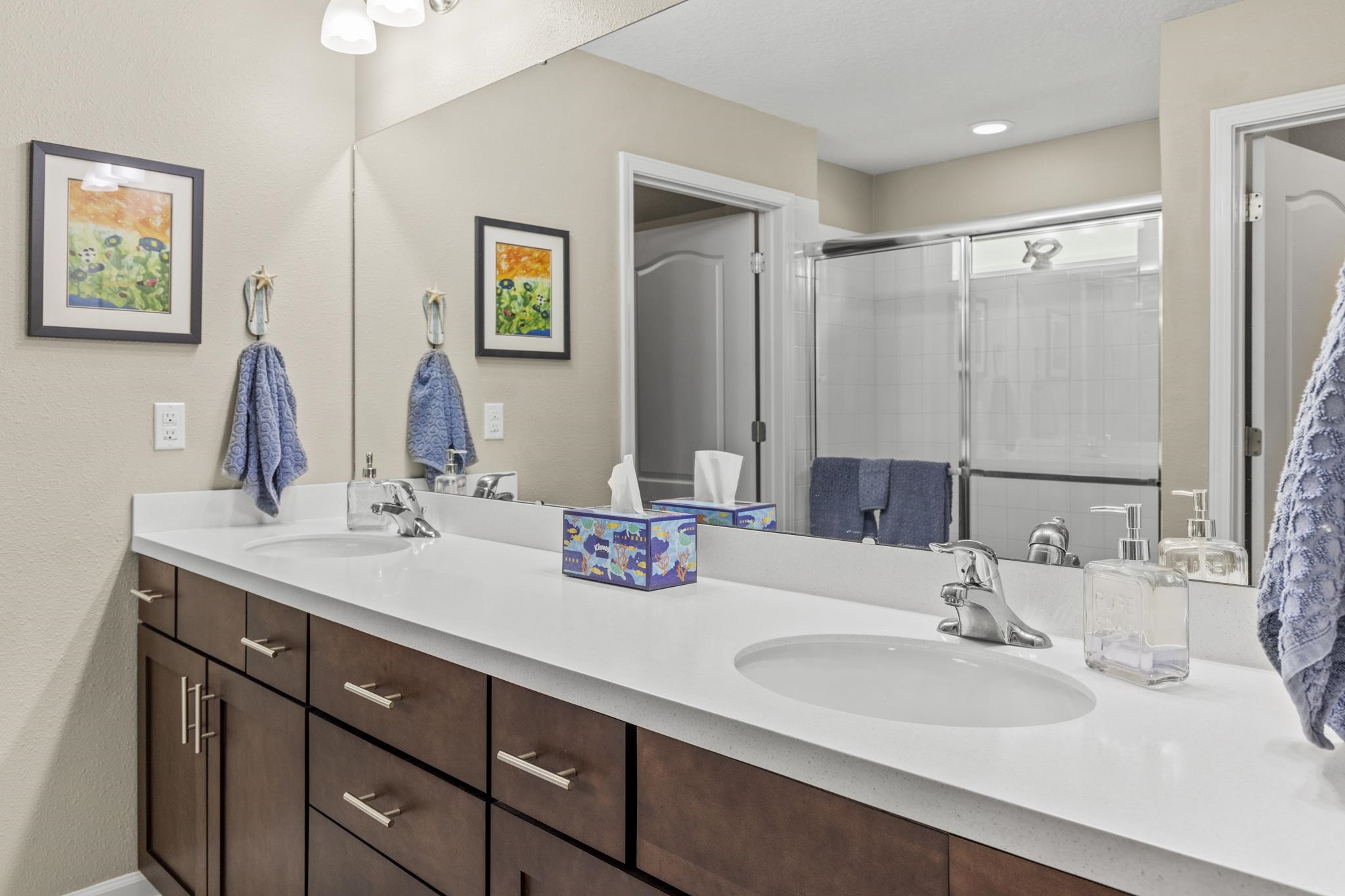 307 Palace Drive St. Augustine, FL 32084 - Photo 25 of 58 a bathroom with double vanity sinks and a mirror