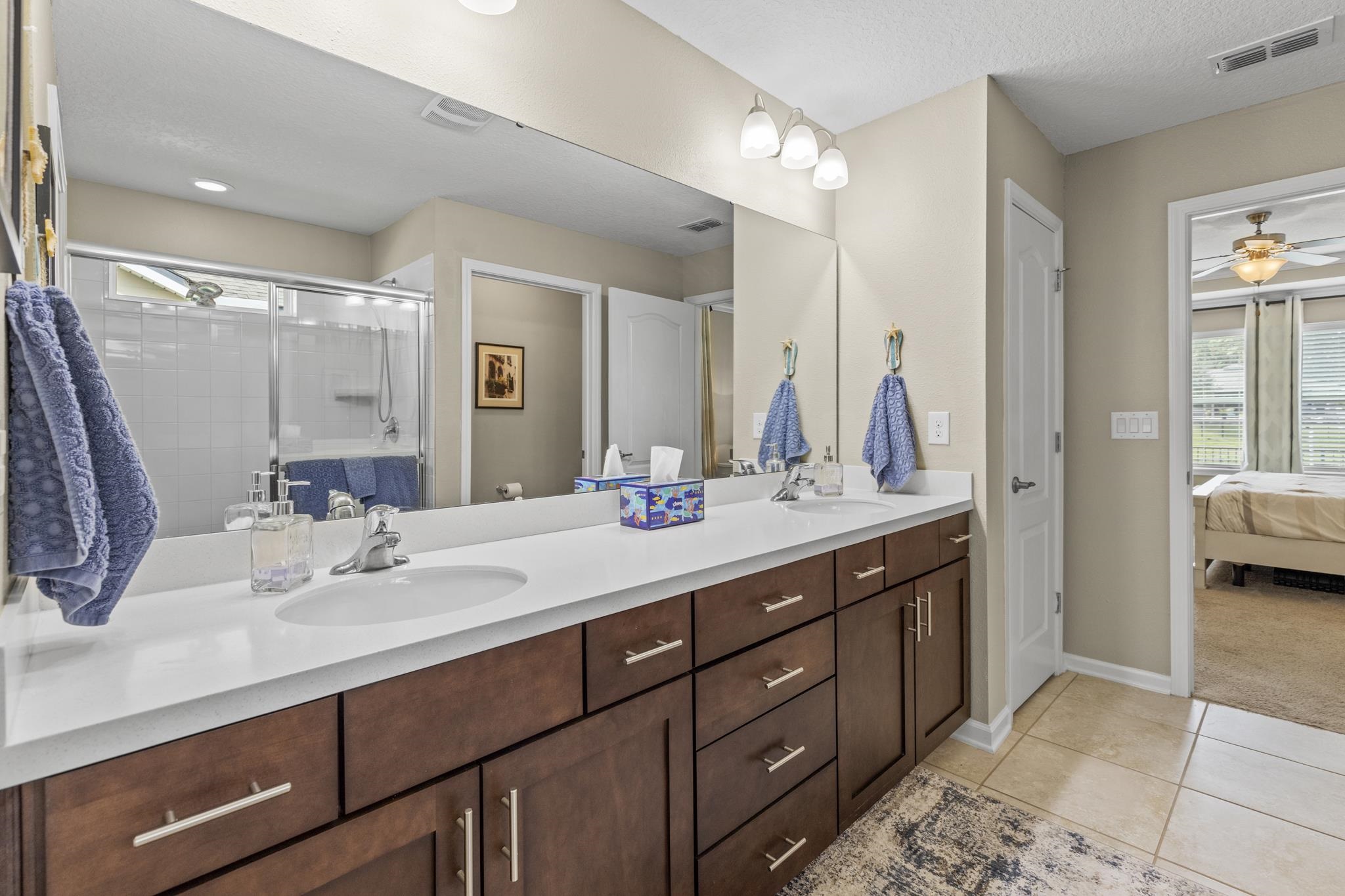 307 Palace Drive St. Augustine, FL 32084 - Photo 27 of 58 a bathroom with a sink double vanity and a mirror