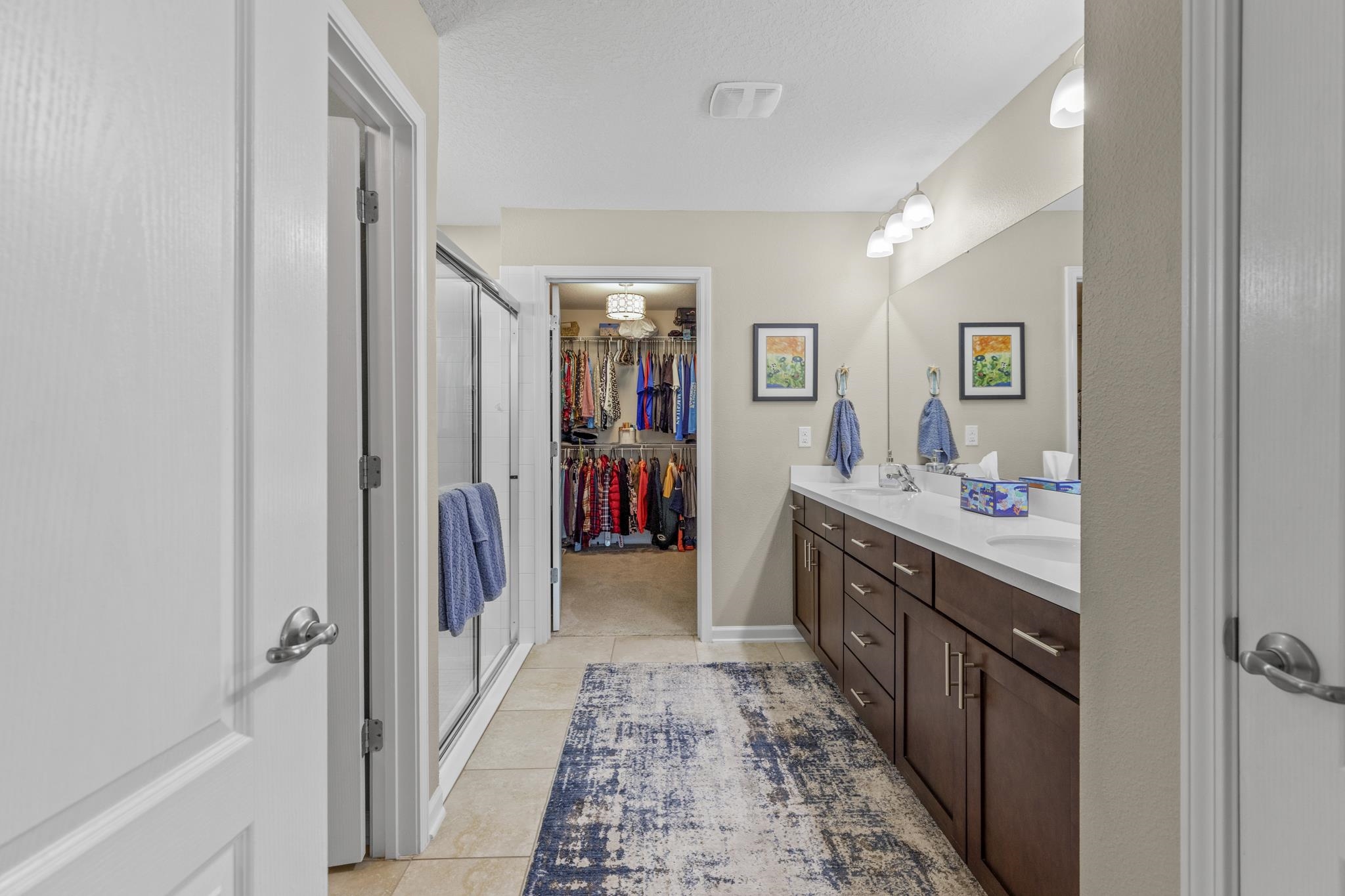 307 Palace Drive St. Augustine, FL 32084 - Photo 28 of 58 a bathroom with a double vanity sink and a mirror