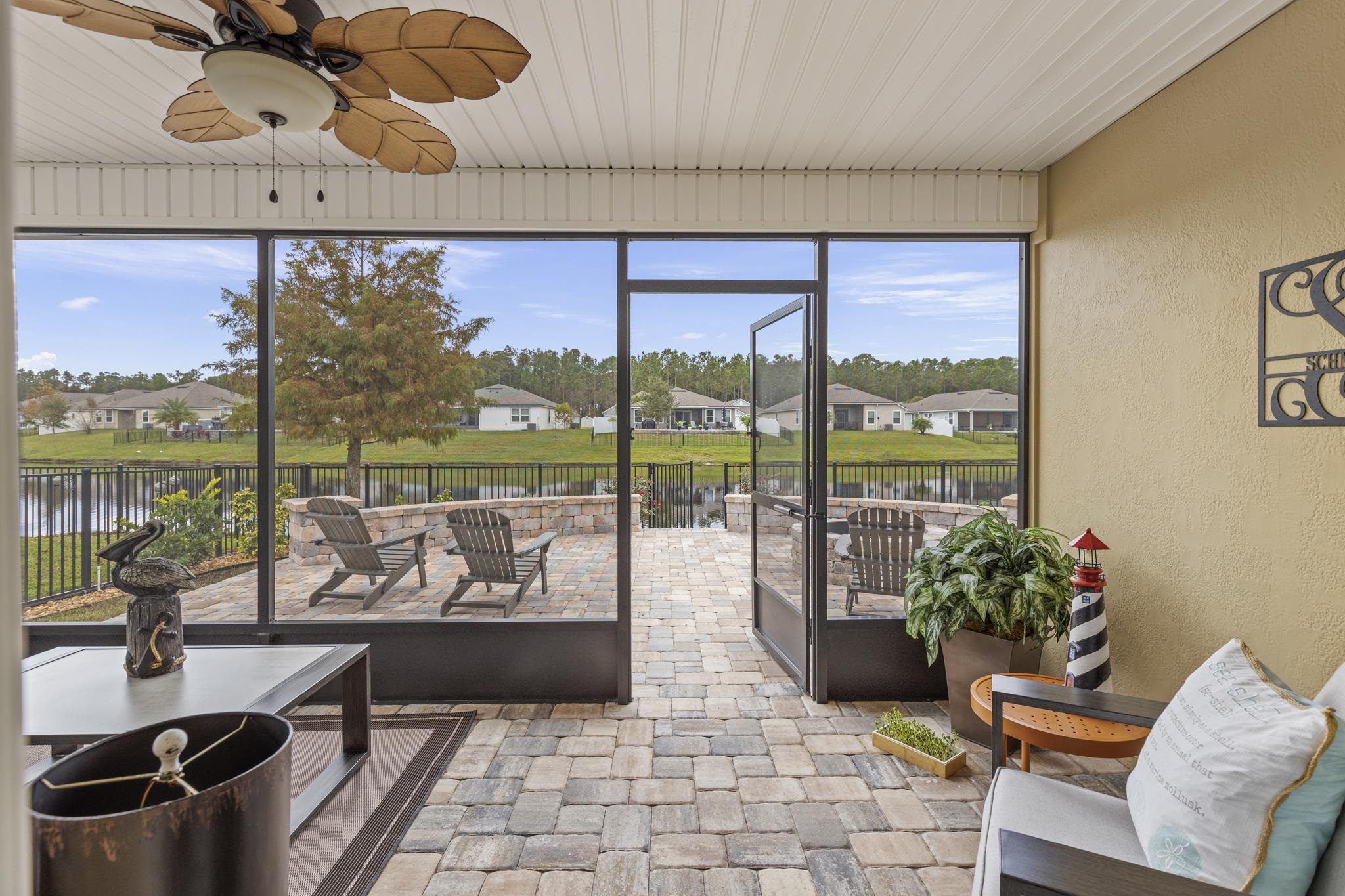 307 Palace Drive St. Augustine, FL 32084 - Photo 36 of 58 a living room with patio furniture and a floor to ceiling window
