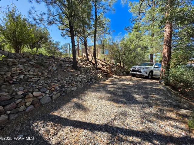 a view of yard with car parked