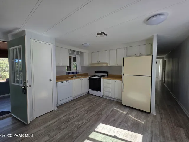 a view of a hallway view with wooden floor and staircase