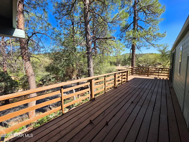 a view of balcony with wooden floor and fence