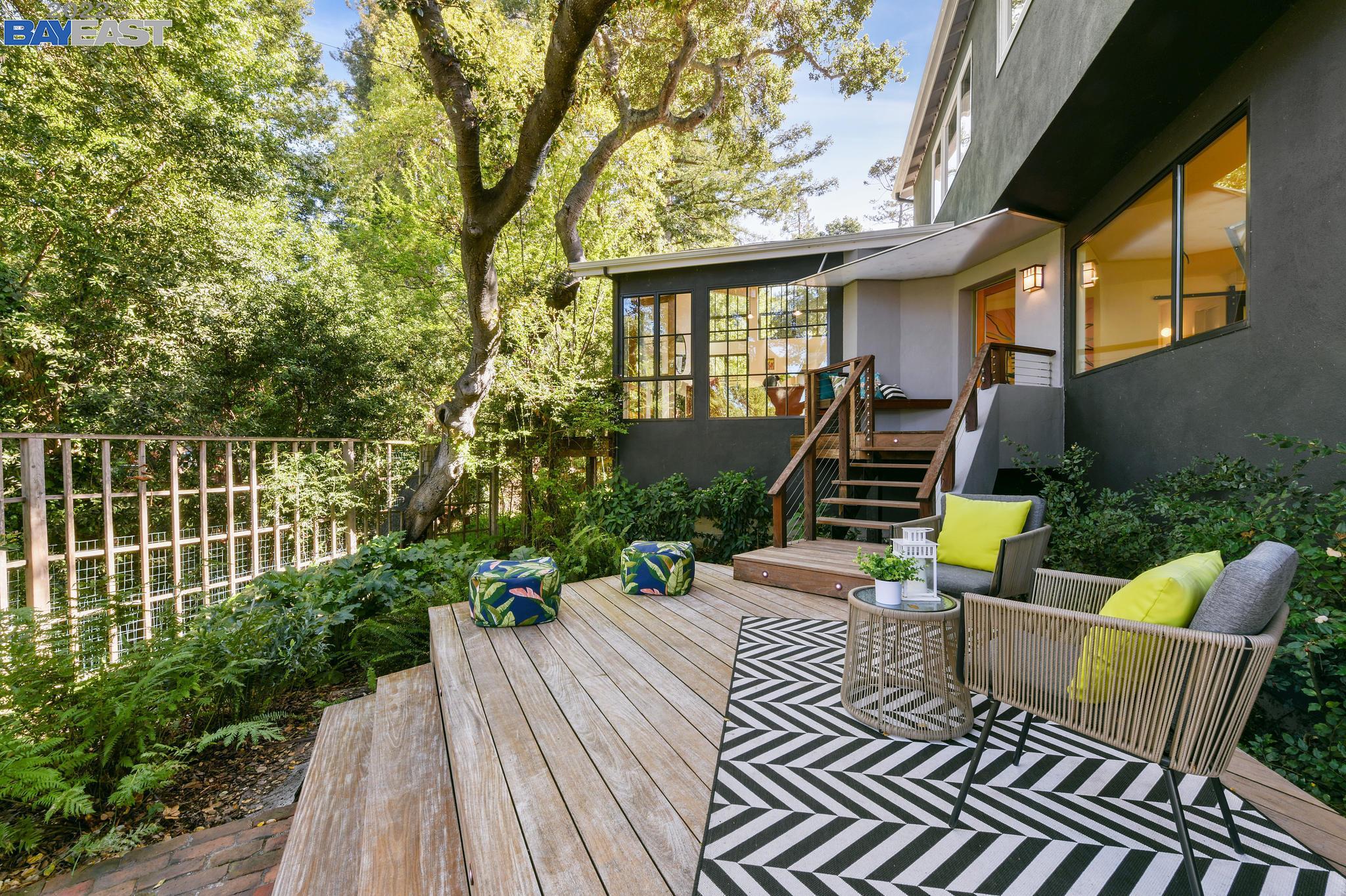 a view of a house with backyard and sitting area