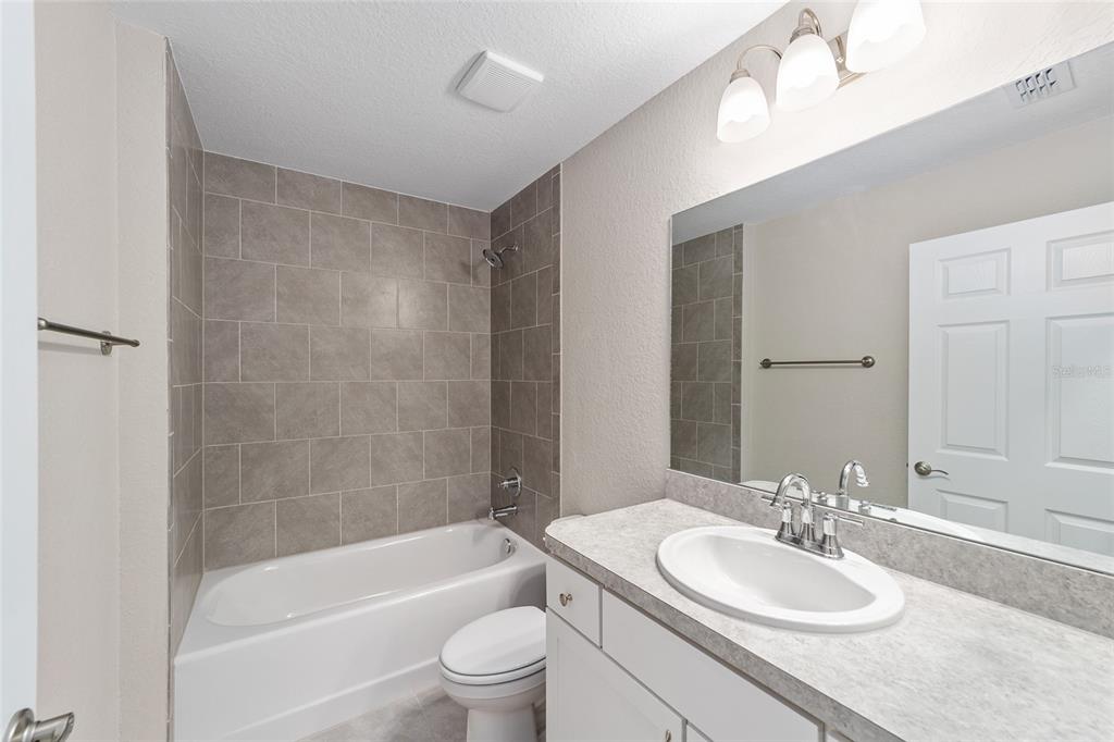 17590 Southwest 112th Place Dunnellon, FL 34432 - Photo 20 of 31 a bathroom with a bathtub shower sink vanity mirror and toilet