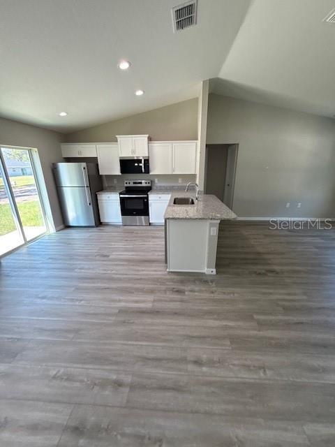 17590 Southwest 112th Place Dunnellon, FL 34432 - Photo 7 of 31 a view of kitchen with stainless steel appliances wooden floor and living room view