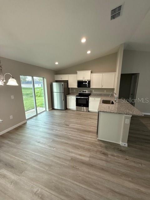 17590 Southwest 112th Place Dunnellon, FL 34432 - Photo 8 of 31 a view of kitchen with microwave a stove and cabinets
