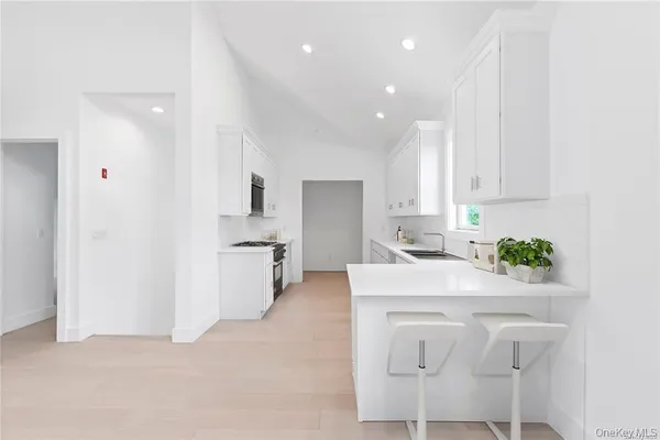 a kitchen with a sink cabinets and window
