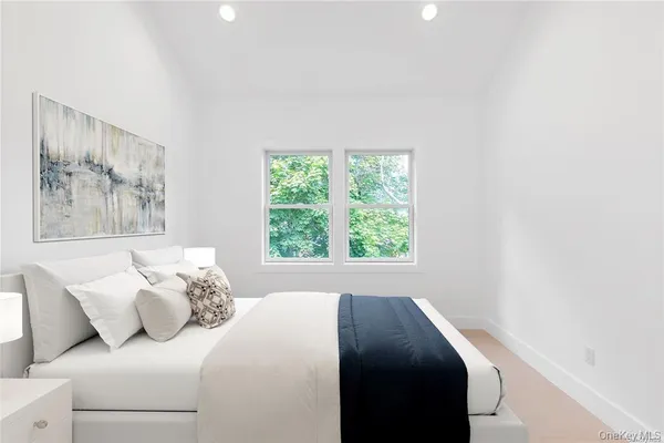 a bedroom with bed and a window