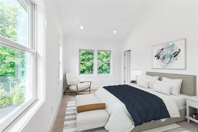 a bedroom with a large bed and a large window with outer view