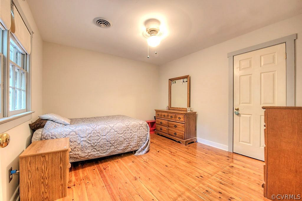 13608 Hunts Bridge Road Midlothian, VA 23112 - Photo 33 of 50 a bedroom with a bed and wooden floor