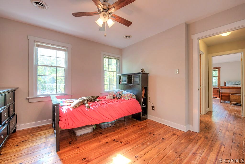 13608 Hunts Bridge Road Midlothian, VA 23112 - Photo 36 of 50 a bedroom with a bed and wooden floor