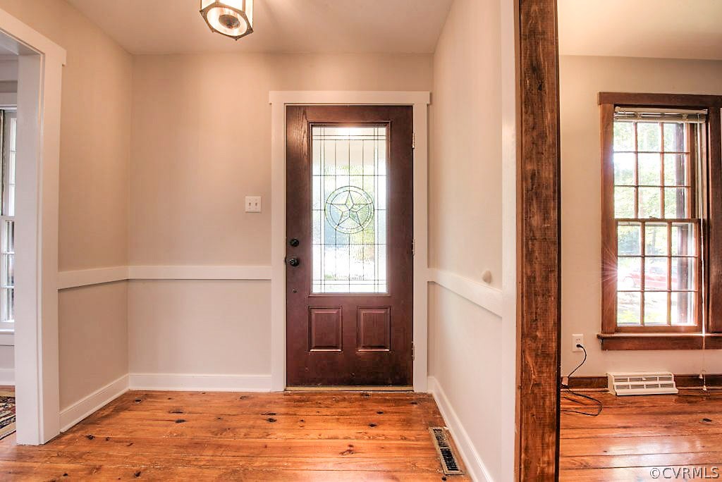 13608 Hunts Bridge Road Midlothian, VA 23112 - Photo 4 of 50 a view of an empty room with wooden floor and a window