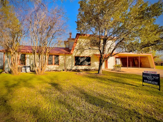 a house view with swimming pool in front of house