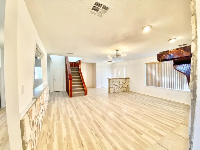 a view of a room with wooden floor and stairs