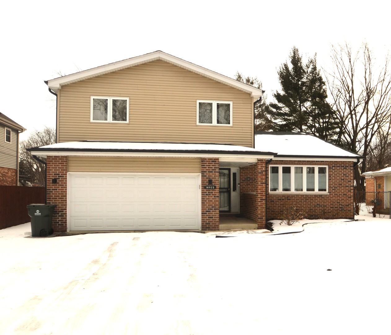 16023 Trumbull Avenue Markham, IL 60428 - Photo 1 of 36 a front view of a house with a yard covered in snow