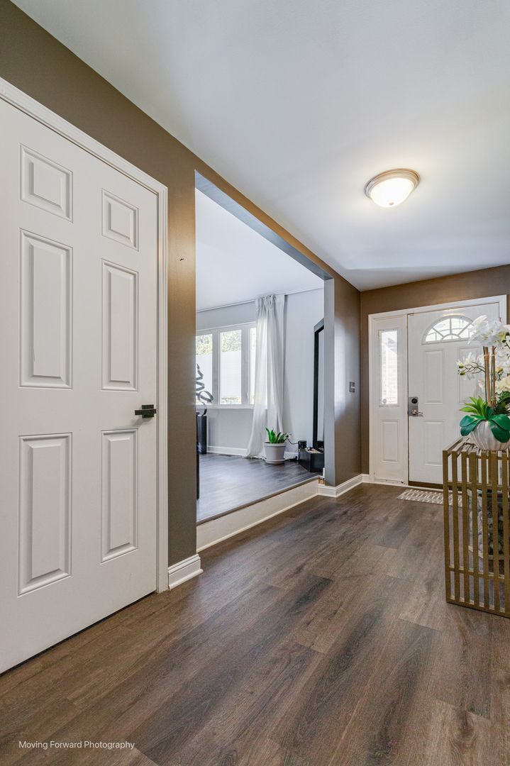 16023 Trumbull Avenue Markham, IL 60428 - Photo 2 of 36 an empty room with wooden floor and windows