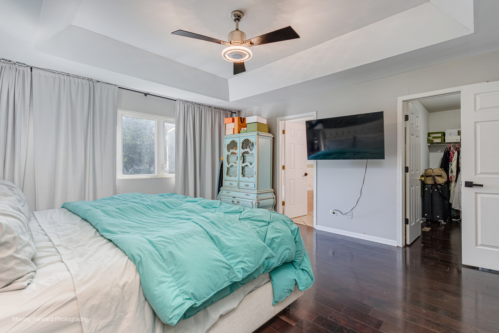16023 Trumbull Avenue Markham, IL 60428 - Photo 22 of 36 a bedroom with a bed a flat screen tv and a chandelier