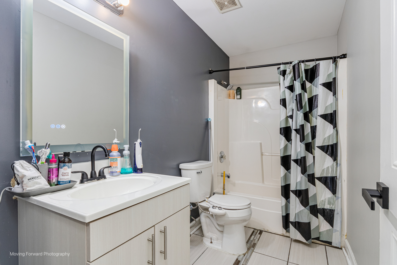 16023 Trumbull Avenue Markham, IL 60428 - Photo 29 of 36 a bathroom with a sink toilet vanity and shower